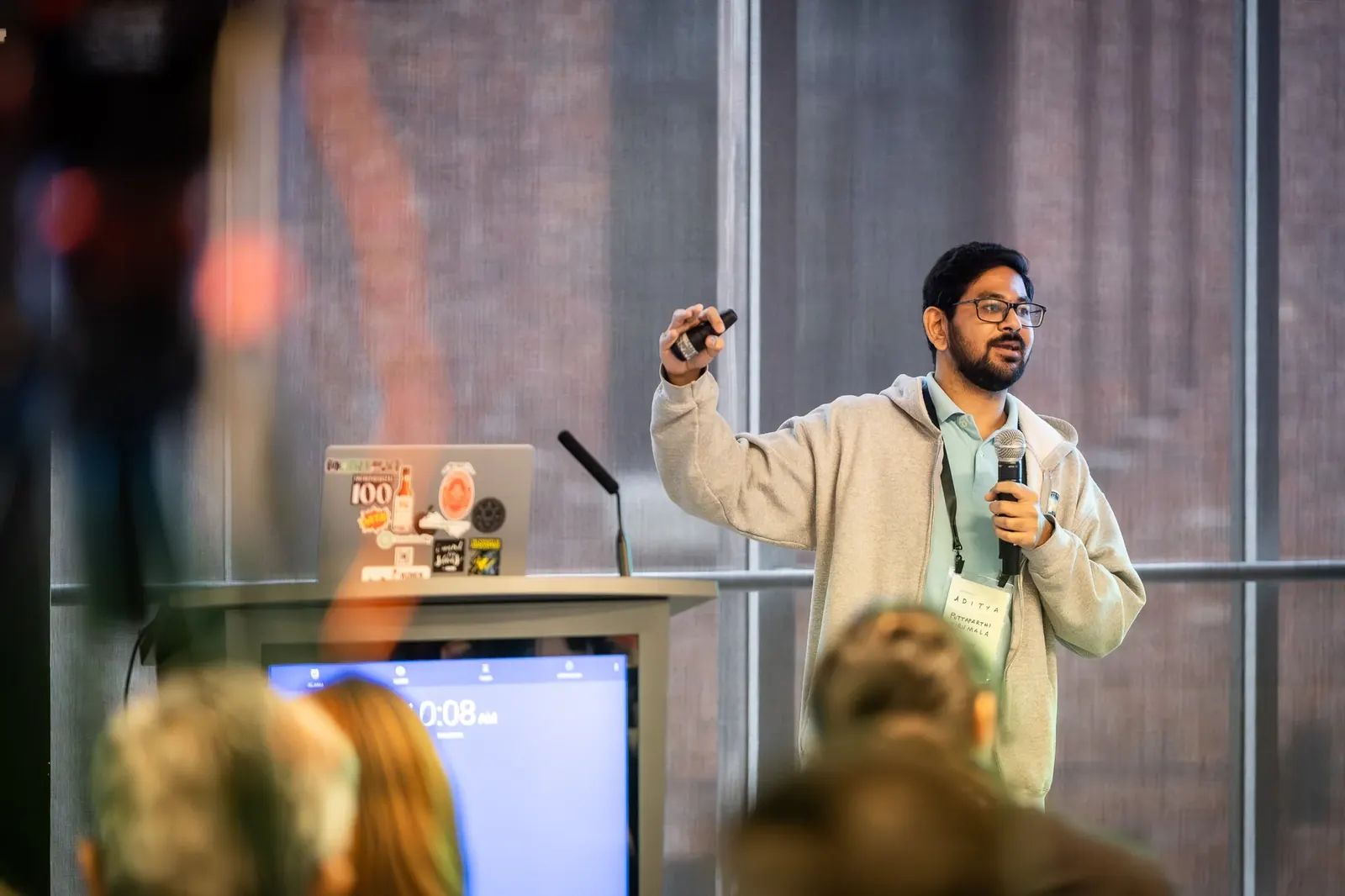 Presenter addressing an audience beside a lectern