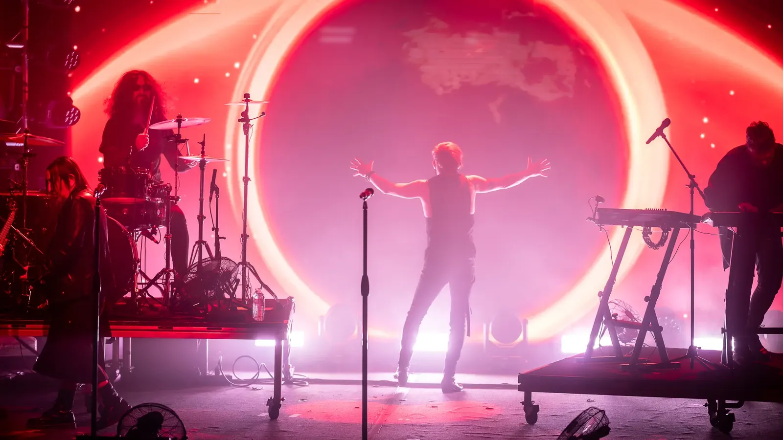 Performer framed by a glowing circular stage light