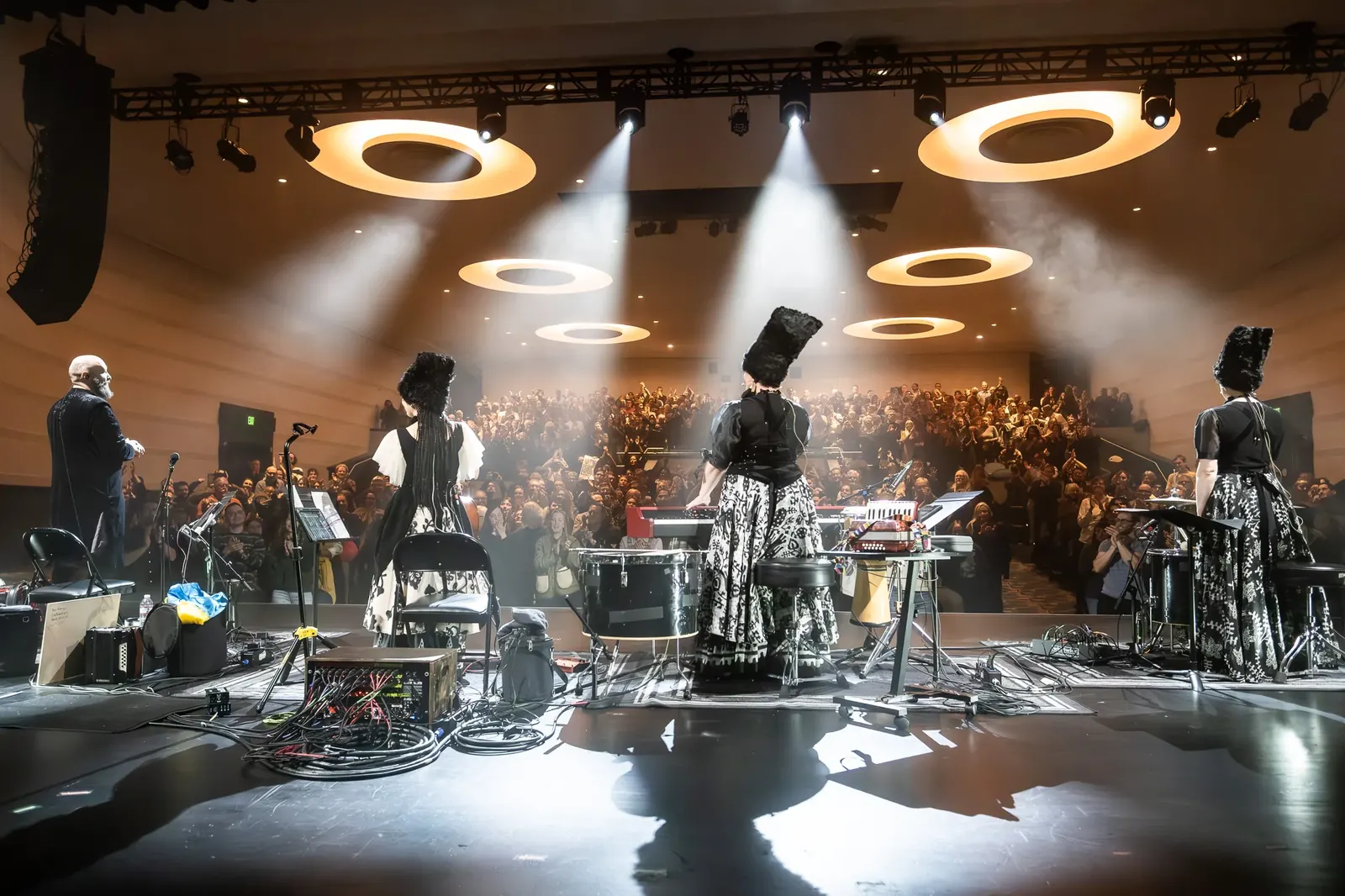 Band and instruments beneath circular stage lights