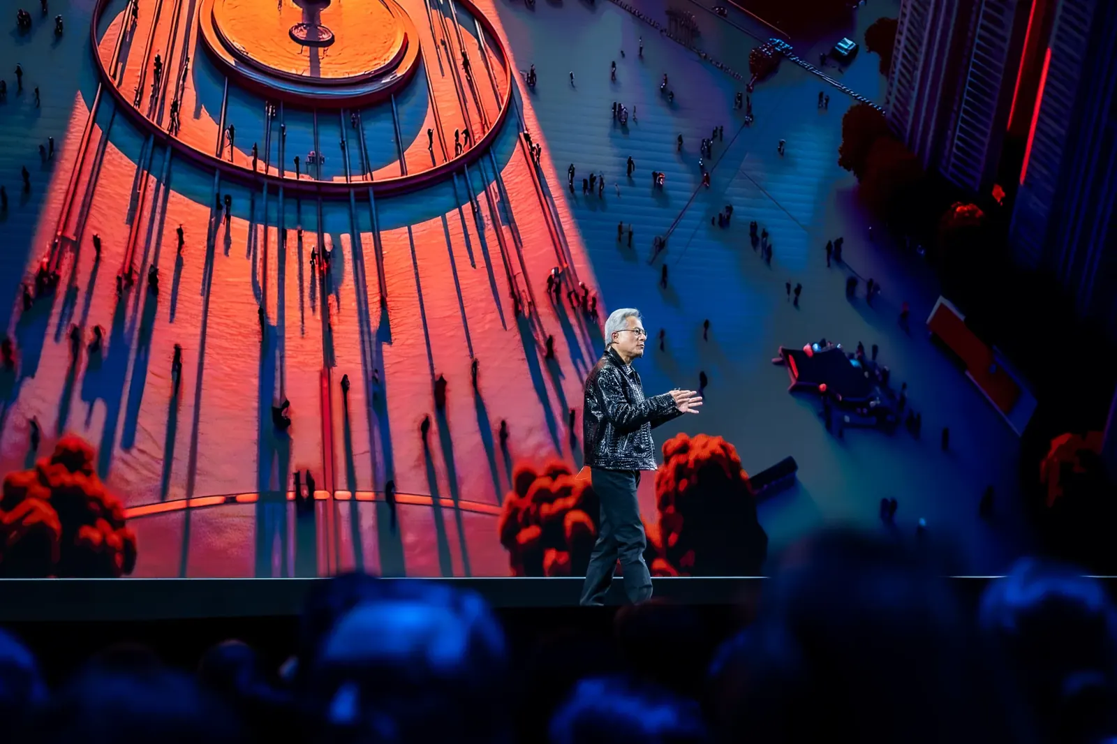 Speaker in front of a vivid orange and blue presentation